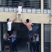 幼童头卡12楼防护网身体悬空：邻居、保安在11楼探出窗外托举，家长在业主群致谢